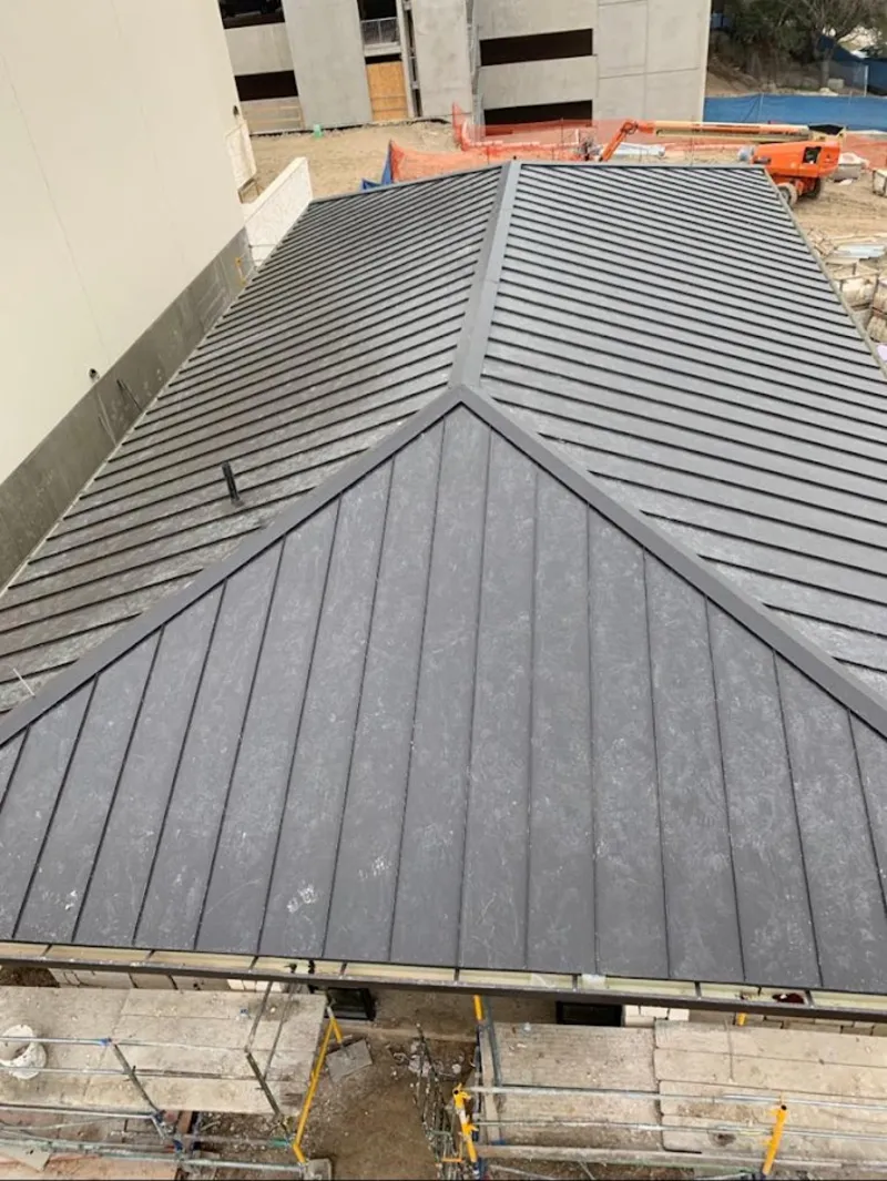 Commercial metal roof construction with crane equipment in Jerseyville