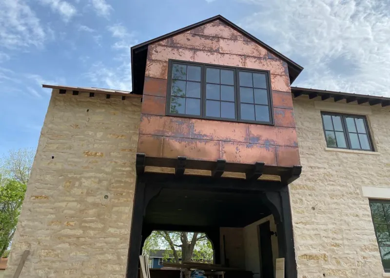 Copper metal panel facade on a stone building for Skylight Installation in Jerseyville