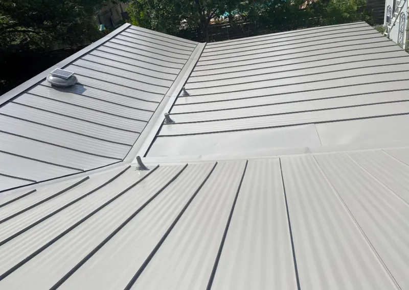 Solar attic fan installed on a metal roof for Roof Ventilation in Jerseyville
